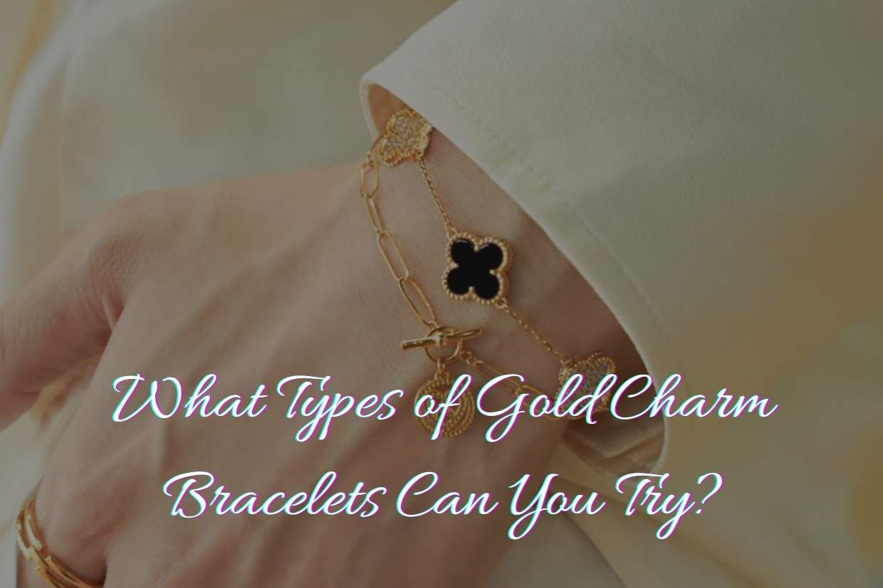 A woman's wrist wearing a gold bracelet with black clover charms and a gold charm.