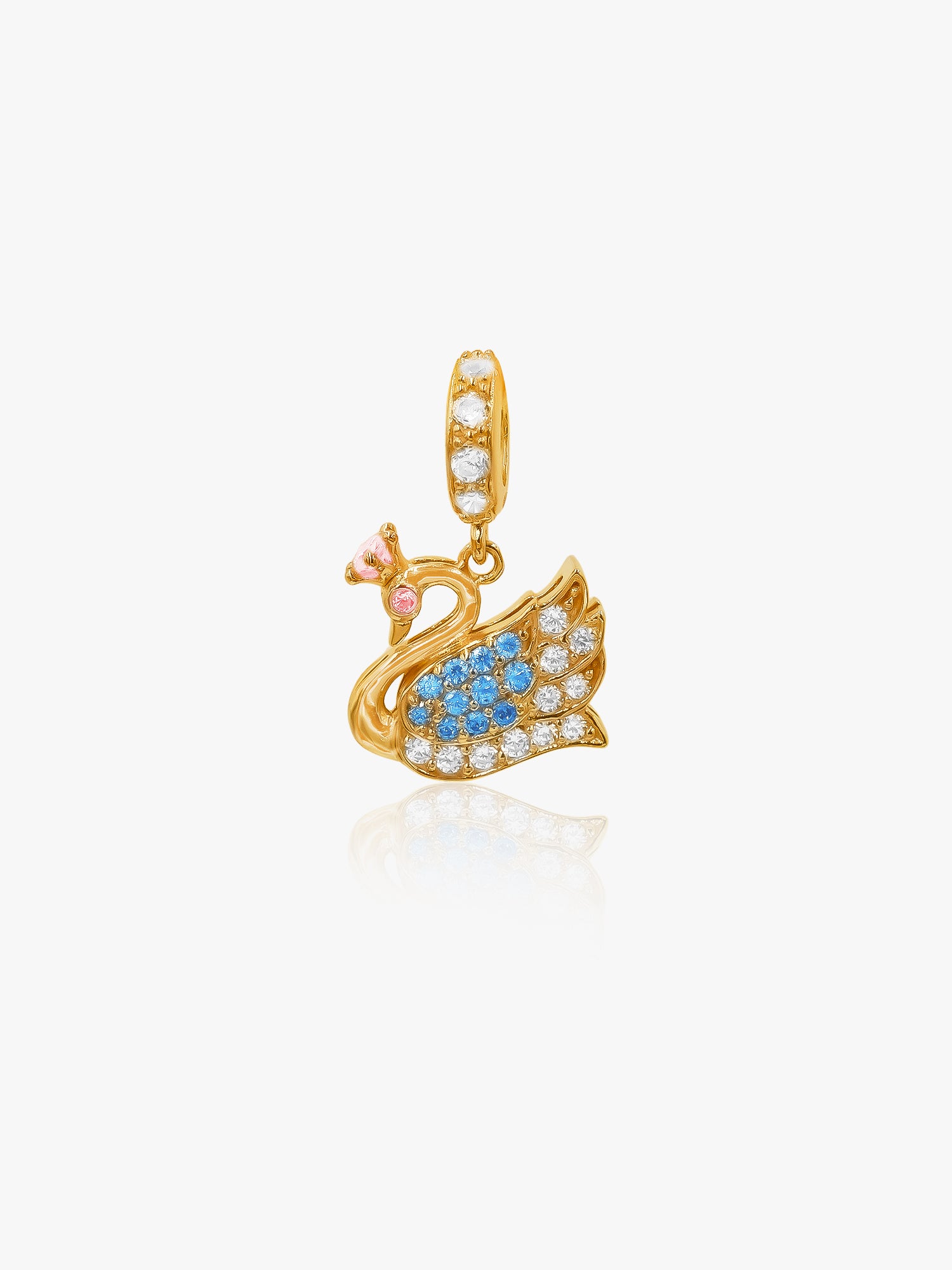 Gold swan pendant with blue stones and a pink gem on a white background