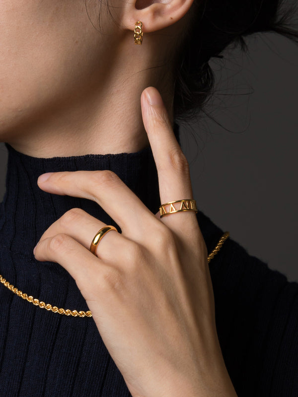 Model wearing gold roman ring 