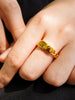 Gold moments ring on female hand model